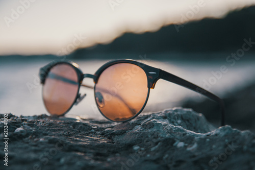 Close up of female sunglasses near the sea
