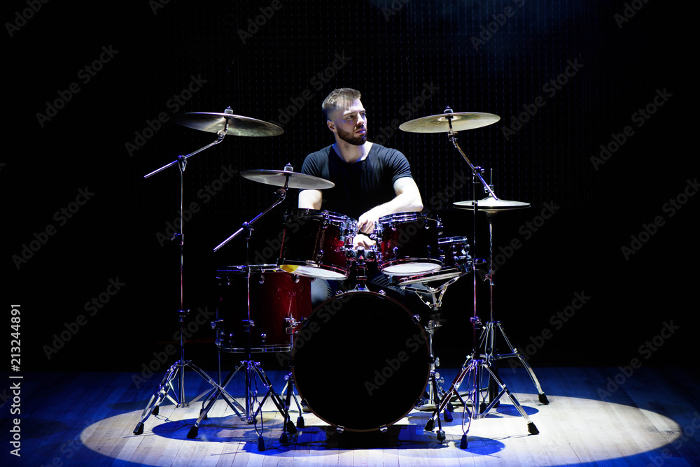 Drummer playing the drums with smoke and powder in the background Drummer playing the drums with smoke and powder in the background