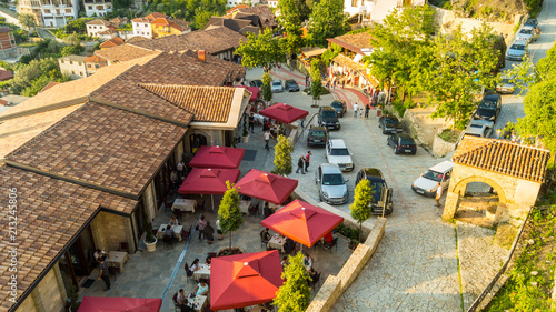 Arial shot of front entry in the castle of Kruja. Restaurants, people, shops, craftsman, antique. 