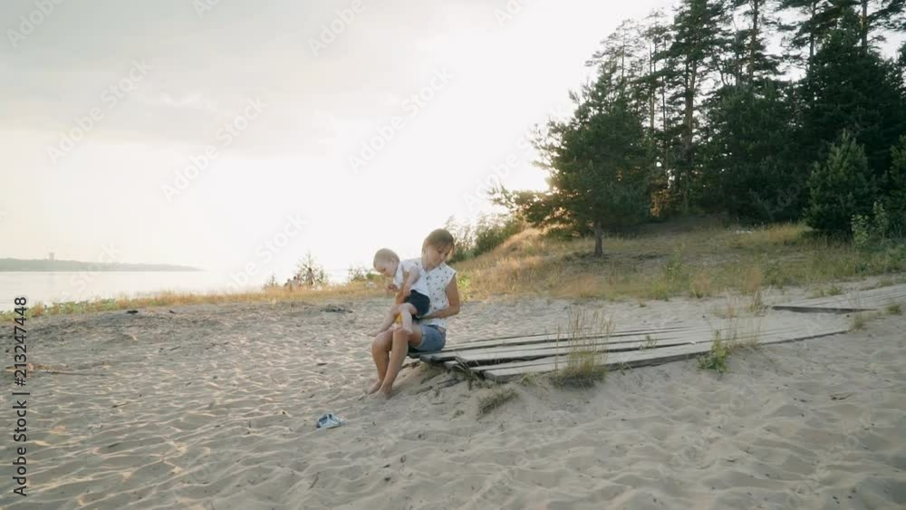 Young mother and little son on the beach. Young mother and little son on the beach.