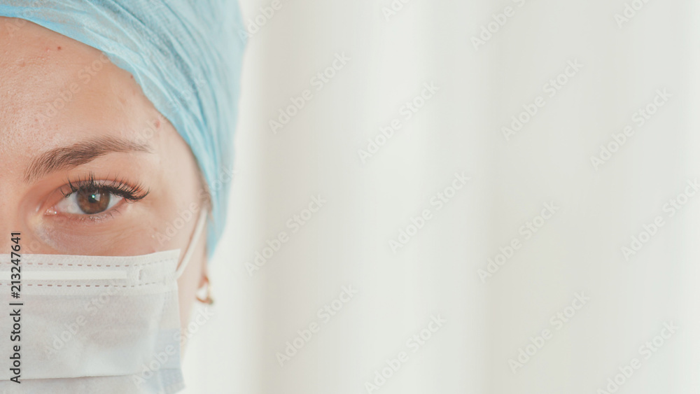 Close-up of young female doctor with a mask on face Close-up of young female doctor with a mask on face