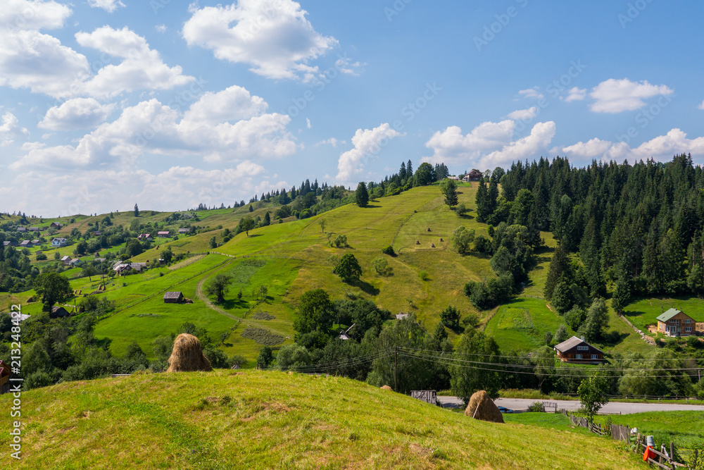 Carpathian village in the valleys with rarely poured down modest houses
