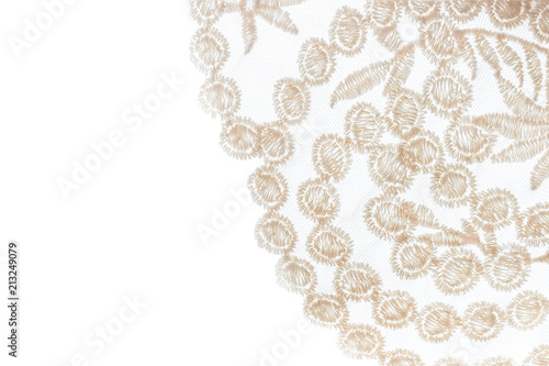 Close-up beige lace on white background with copy space. 