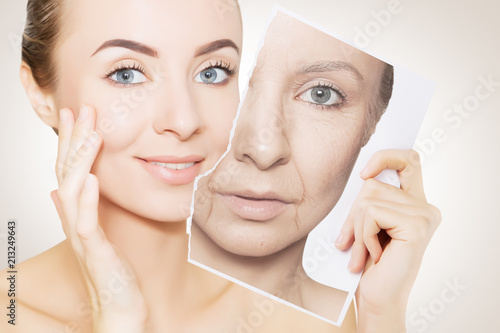 portrait of young woman face holding portrait with old wrinkled face