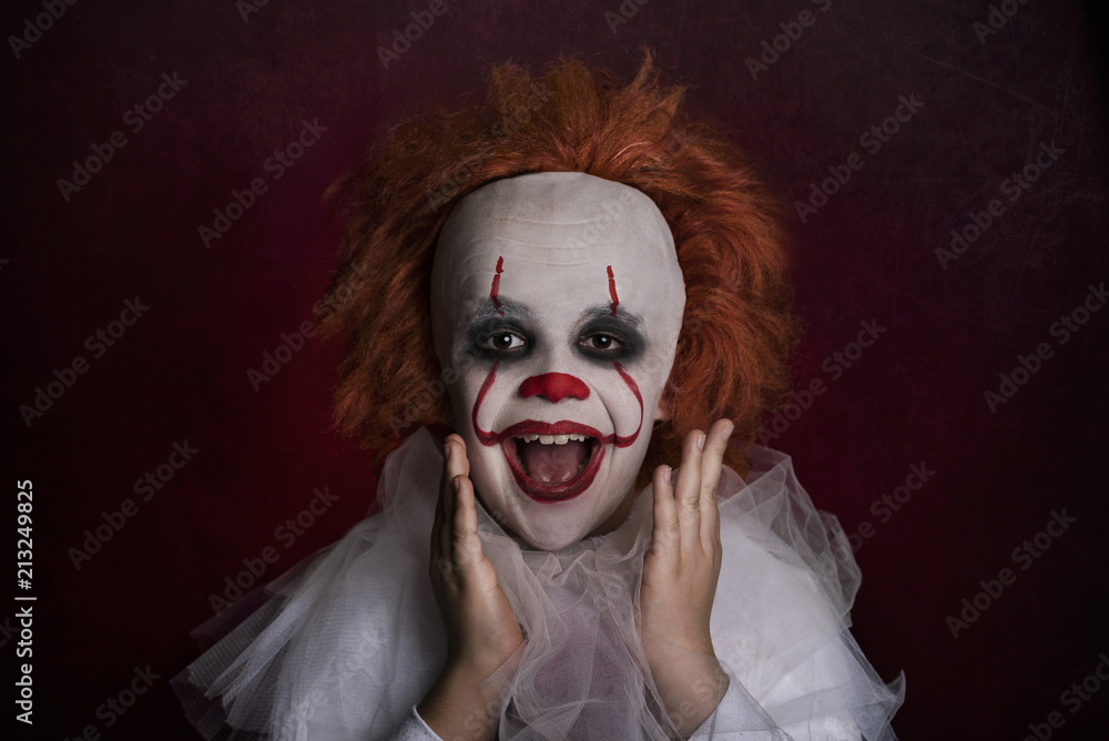smiling boy dressed as a clown smiling boy dressed as a clown