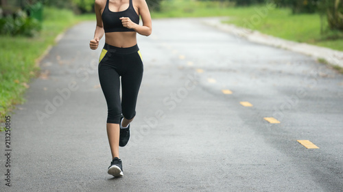 Young fitness sport woman running on the road in the morning, Selective focus