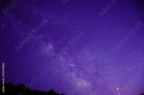 The Milky Way at night with purple sky.