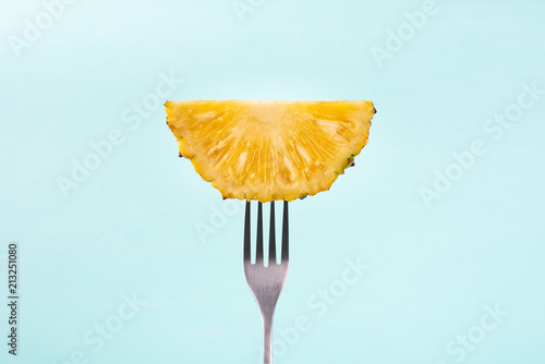 Slice pineapple on fork for eating, tropical fruit