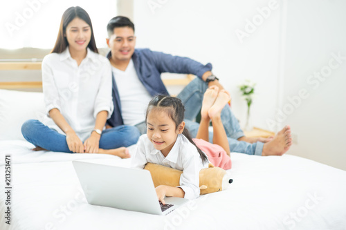 Young happy family relaxing at home, Family using laptop at home