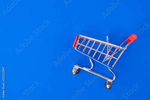 Shopping cart on blue background