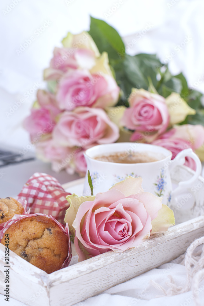 Coffee and bouquet of pink roses in bed, romance and coziness. Good morning. Breakfast in bed. Copy space. Coffee and bouquet of pink roses in bed, romance and coziness. Good morning. Breakfast in bed. Copy space.