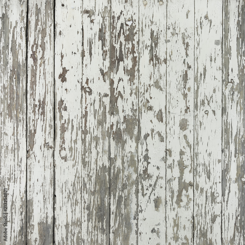 Fototapeta premium old and grungy vertical wooden planks with peeling white paint