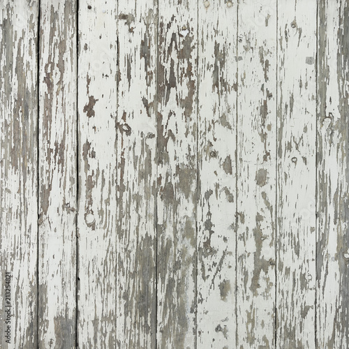 old and grungy vertical wooden planks with peeling white paint