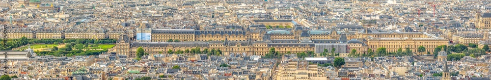 Aerial panorama of the long Louvre Museum palace Famous landmark of Paris with Paris skyline and its historical buildings with typical french architecture roofs.