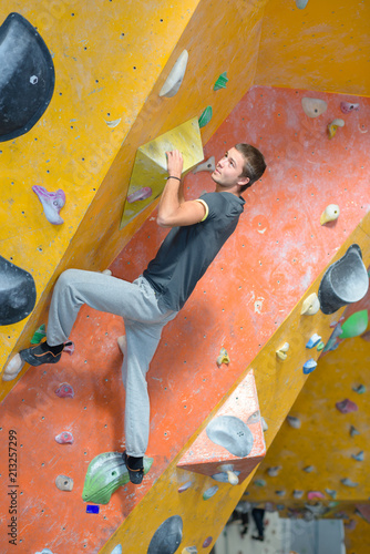 young man climbing indoor structure