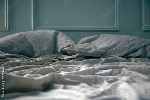 Empty unmade bed photo