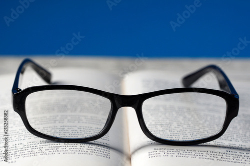 Fototapeta Naklejka Na Ścianę i Meble -  An eyeglasses and a book