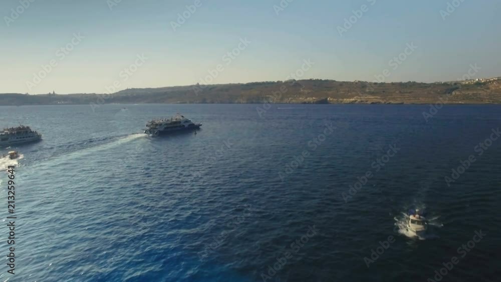 Aerial shot following a small cruise boat Aerial shot following a small cruise boat