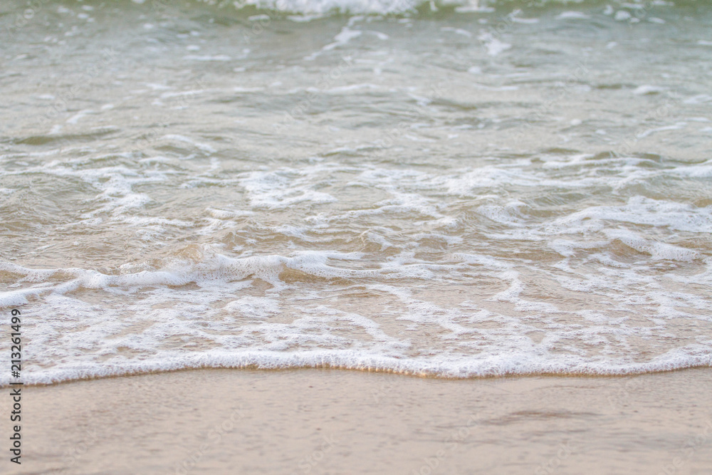 The sea waves on the beach in the morning, the sun is not soft focus The sea waves on the beach in the morning, the sun is not soft focus