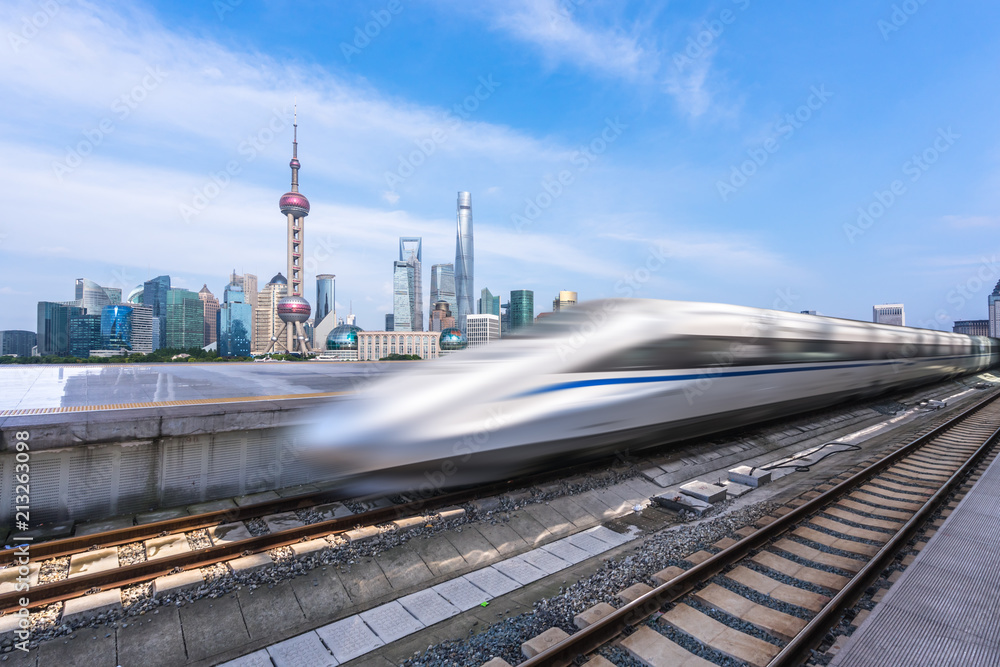 Fototapeta premium high speed train with city skyline in shanghai china