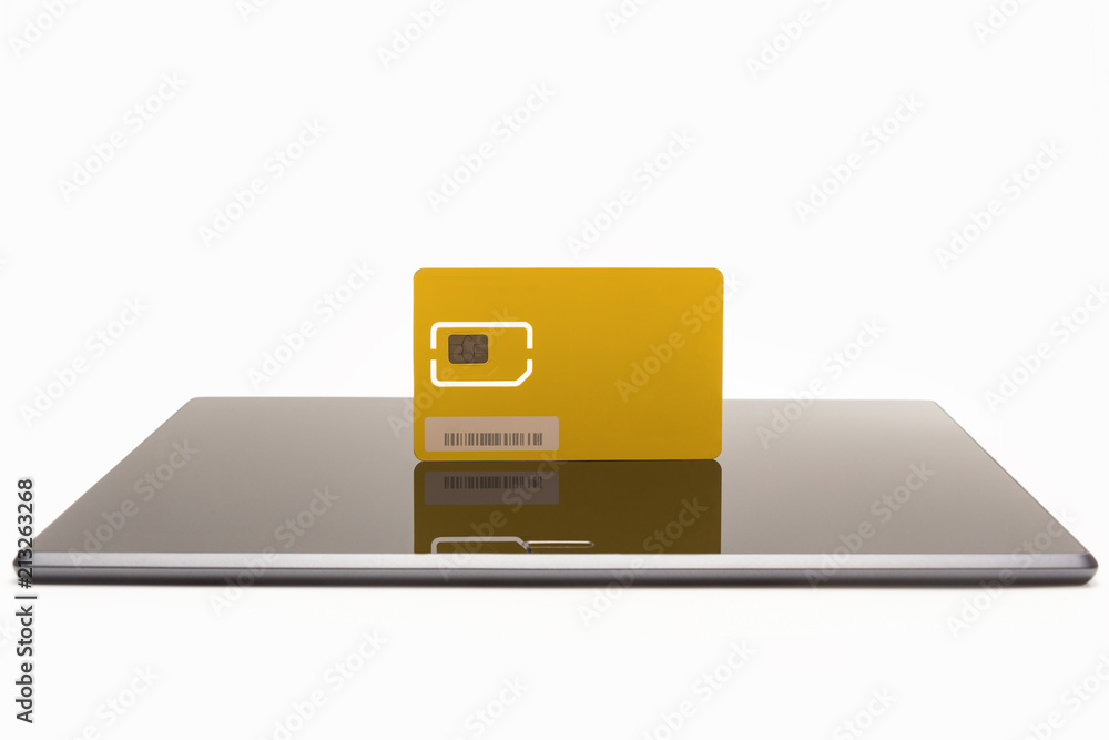 Modern yellow sim card on tablet