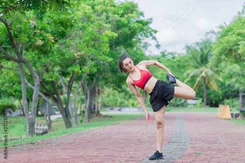 Asian sporty woman stretching body breathing fresh air in the park,Thailand people,Fitness and  exercise concept,Jogging in the park © reewungjunerr