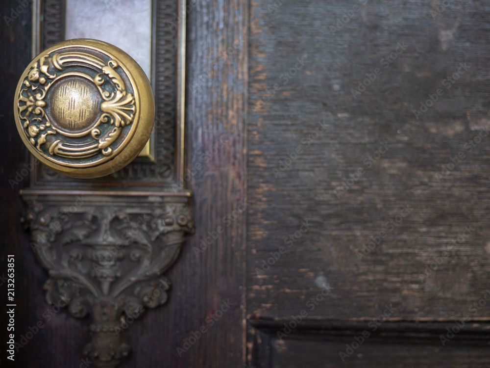 antique doorknob on old rustic brown wooden door antique doorknob on old rustic brown wooden door