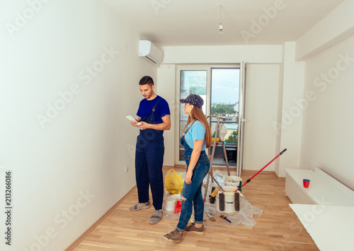 Young couple prepare to painting wall at home. Young couple home renovation concept.