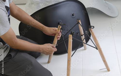 carpenter putting together parts of chair.