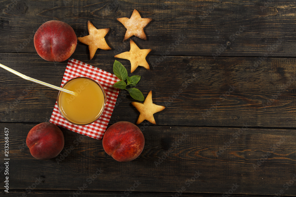 Peach fresh juice with fresh peaches on a dark background. Top view, copy space. Healthy eating. Fresh juice with peach.
