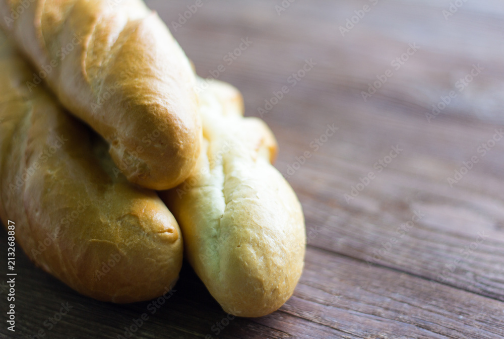 fresh baguettes close-up on wooden background