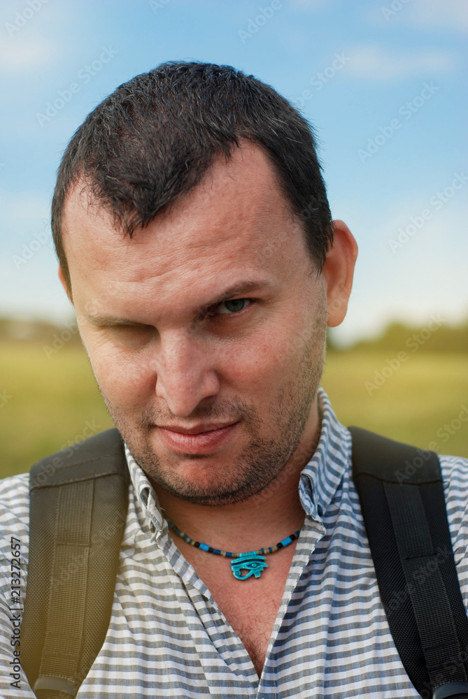 Fototapeta premium Young man with backpack, close up portret stylish copy space walking in the park
