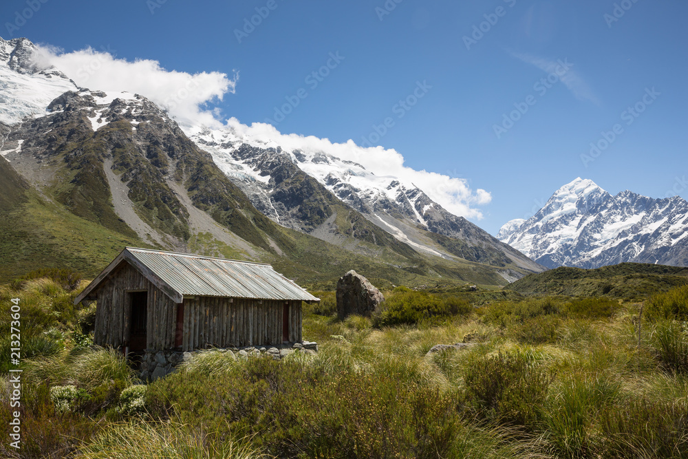 Hut in Aoraki Mount Cook national park, south island, New Zealand. Mount Cook visible in the distance