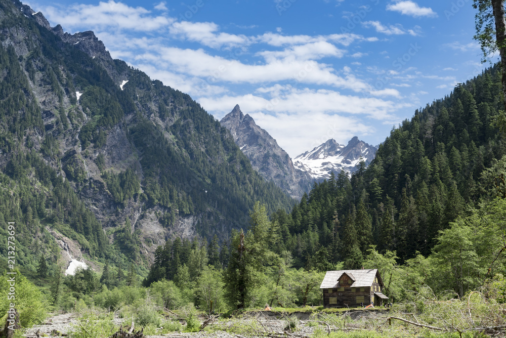 Abandoned mountain cabin chalet cottage in pristine wilderness in Washington horizontal landscape.
