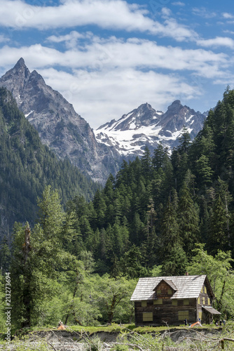 Abandoned mountain cabin chalet cottage in pristine wilderness in Washington vertical portrait.