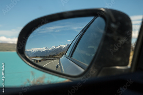 Looking back at Aoraki Mount Cook national park, south island, New Zealand. from a car rear view wing mirror © Michael Evans