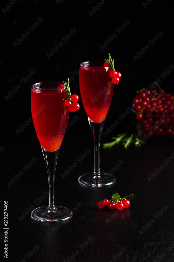 Two glasses redcurrant wine drink juice decorated with rosemary berries Two glasses redcurrant wine drink juice decorated with rosemary berries