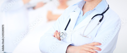 Unknown female doctor with medical staff  at hospital. Closeup of stethoscope