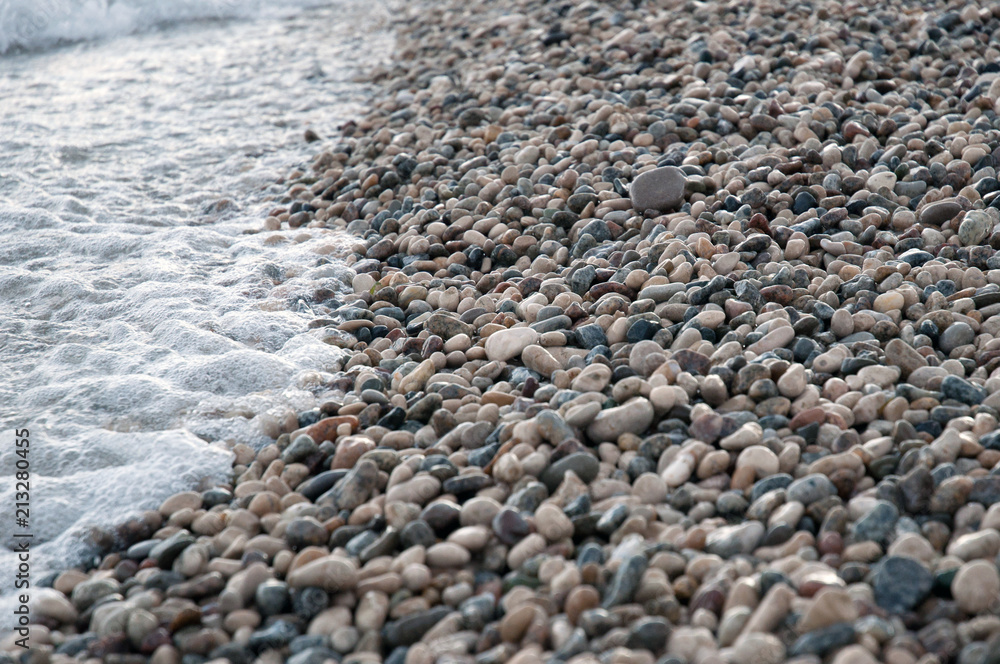 small round sea stones, pebbles on the beach small round sea stones, pebbles on the beach