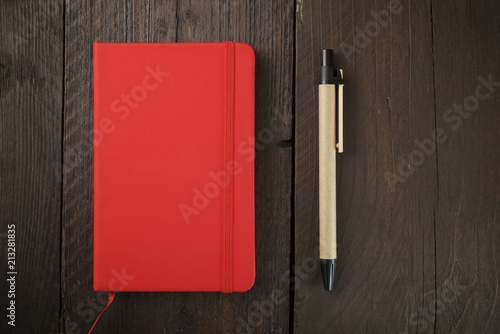 Overhead view of diary with pen on wooden table photo
