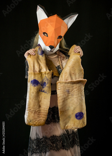 Blonde Girl with Fox Mask paper Using Pig Skin for Covering. Dead Animal Consumer photo