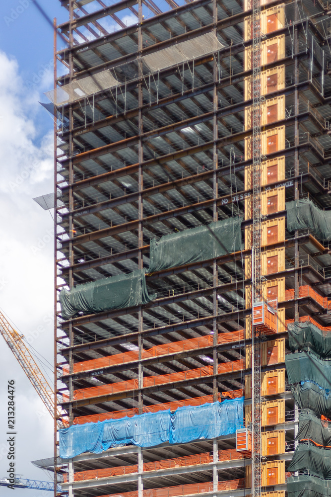 Naklejka premium Detail of a Skyscraper Under Construction in an Urban Downtown