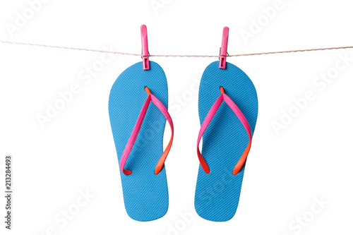 Blue flip flops hanging on clothesline isolated on a white background. Vacation concept