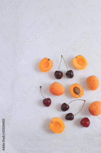 Apricots and cherries isolated on white backgroud Summer fruit and berries concept Harvesting Organic fruits Copy space