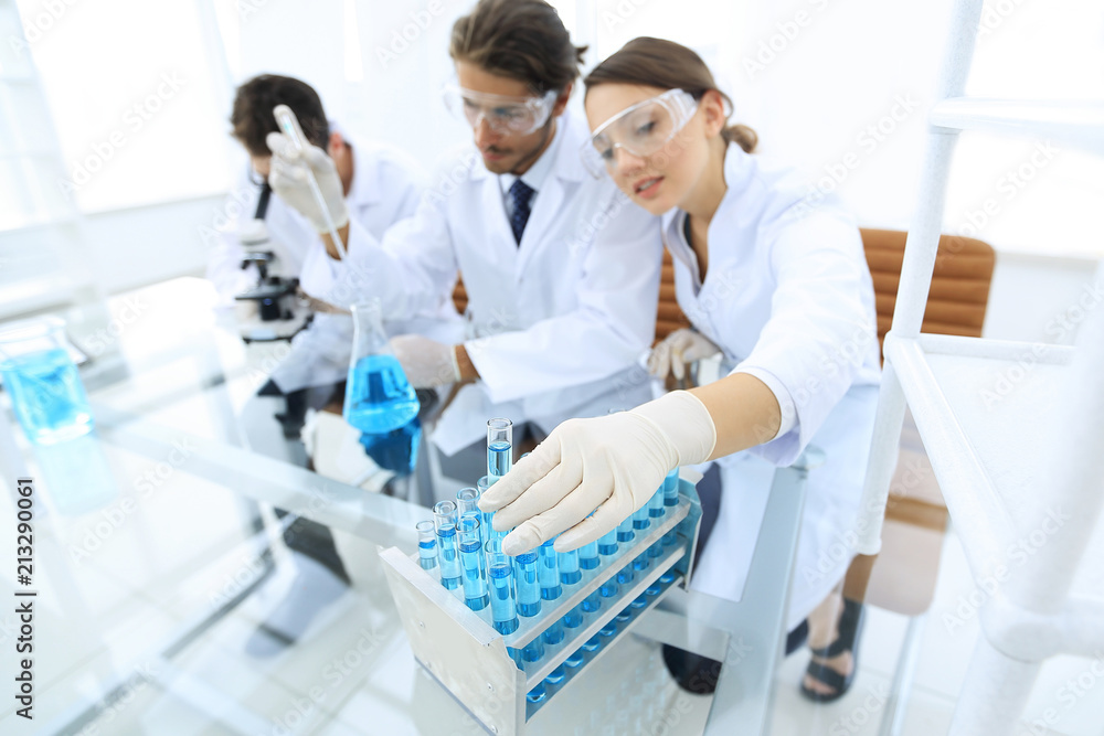 Scientist holding test tube or some equipment of science