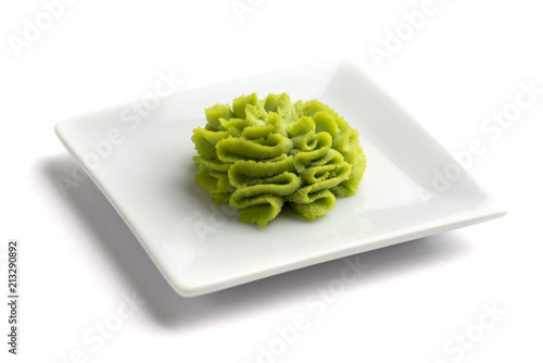 Portion of wasabi in a white gravy boat.