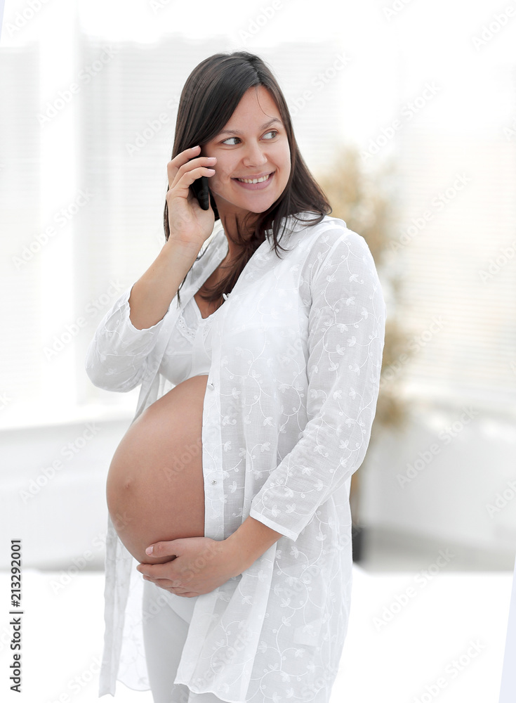 beautiful pregnant woman talking on her smartphone. beautiful pregnant woman talking on her smartphone.