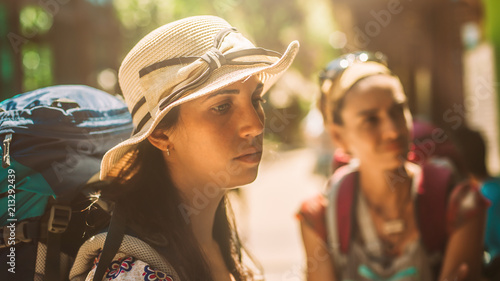 Two woman friends with backpacks enjoying the trip