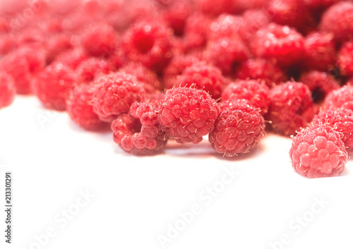 Dripping raspberry on white background.