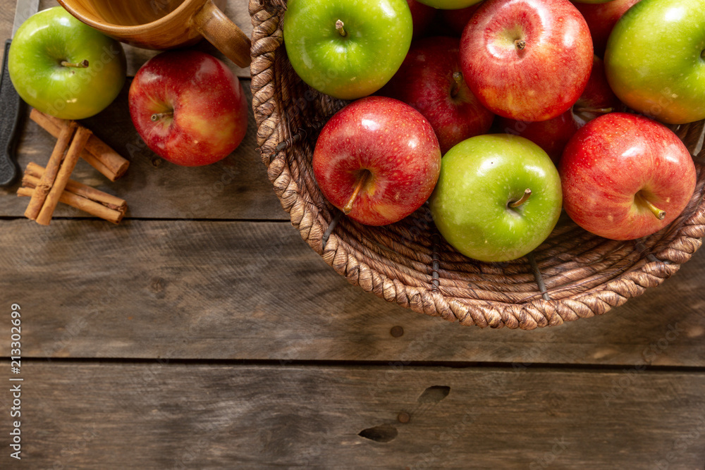 Apples red and green on rustic wooden table in basket Apples red and green on rustic wooden table in basket